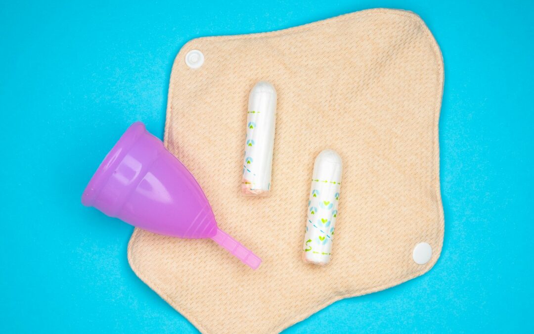 two toothbrushes and a purple cup on a blue background